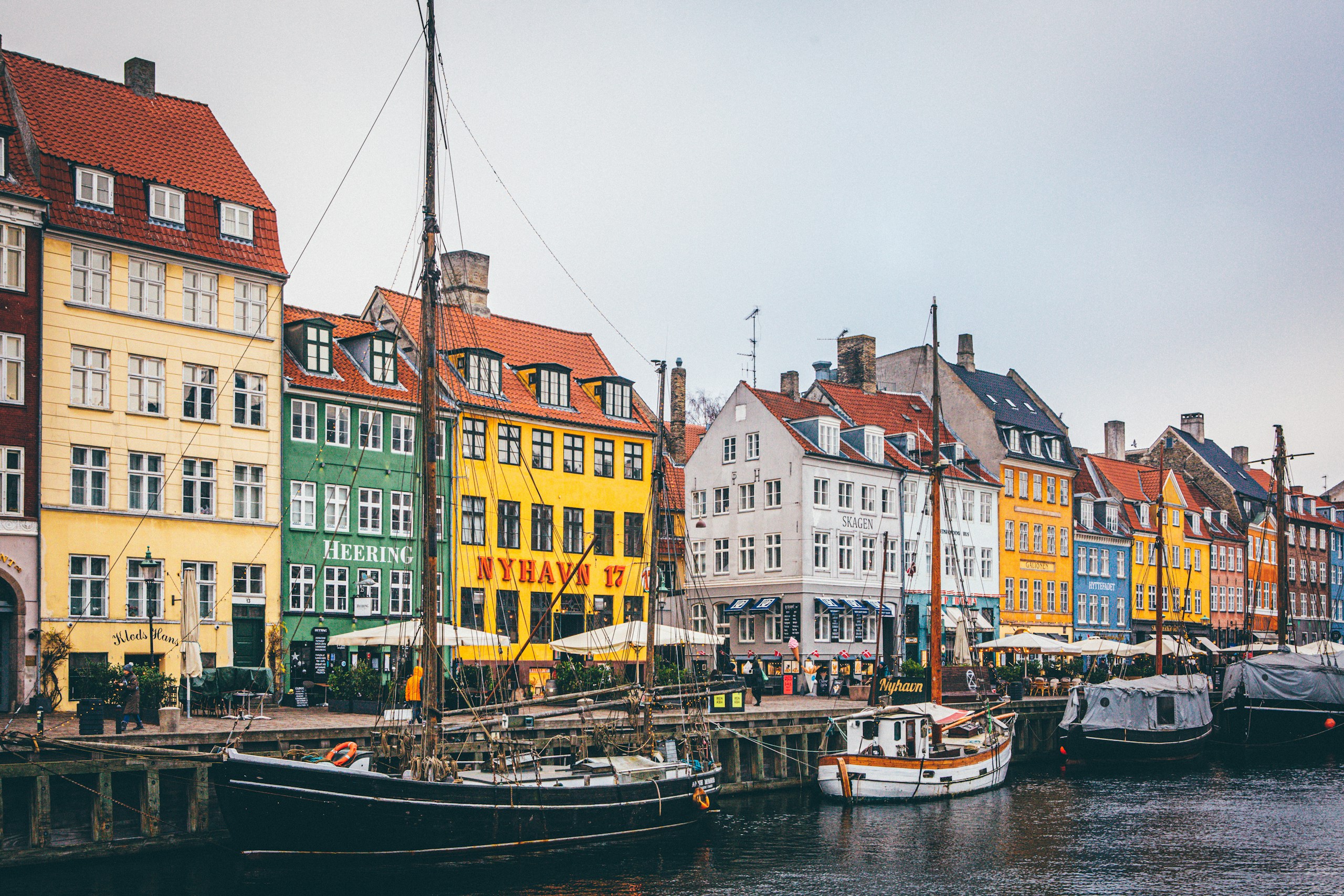 Colourful historic buildings and boats along Nyhavn in Copenhagen, Denmark.