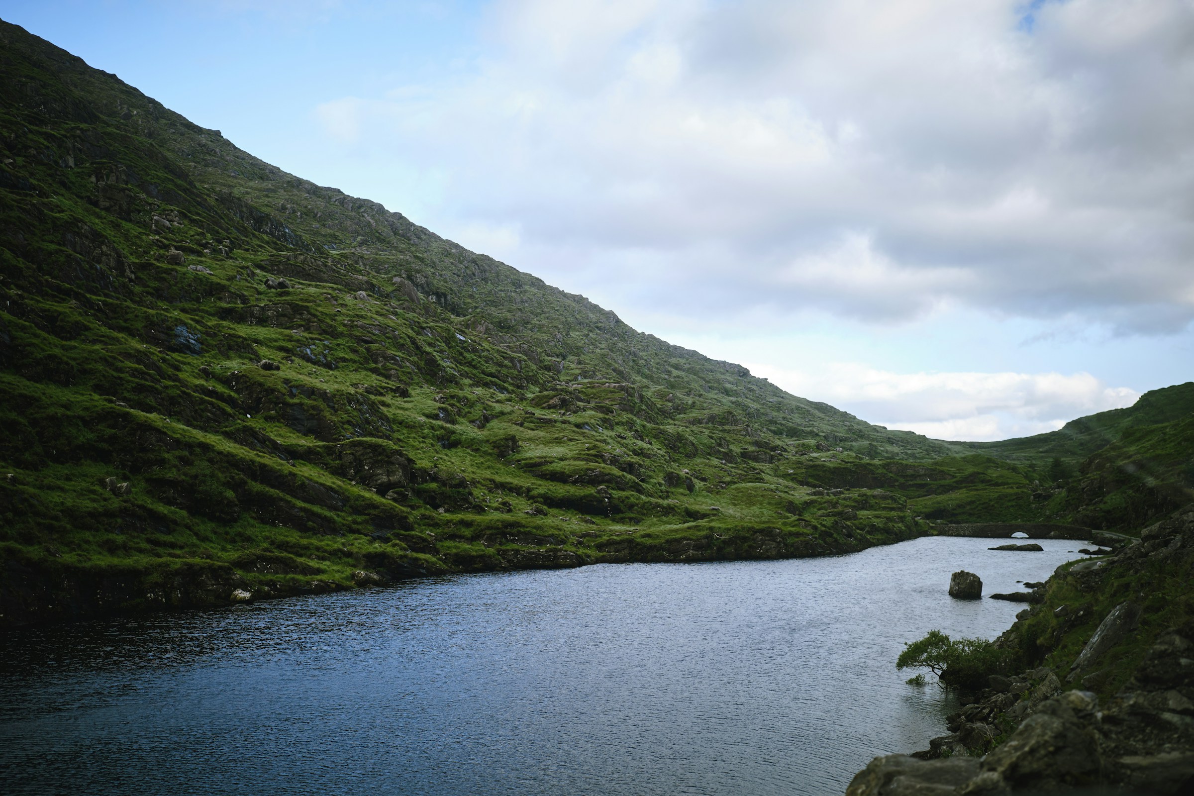 Lake and green hills on the Ring of Kerry, Ireland.