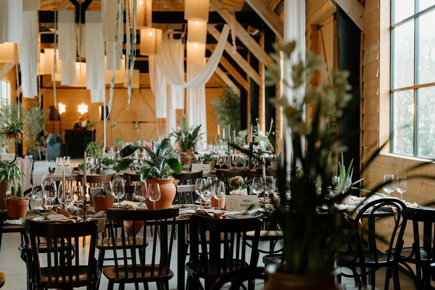 Elegant timber barn reception with long candlelit tables